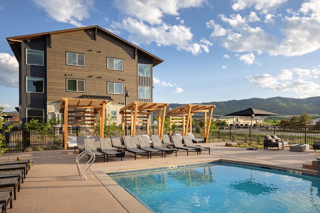 A large house with a pool in front.