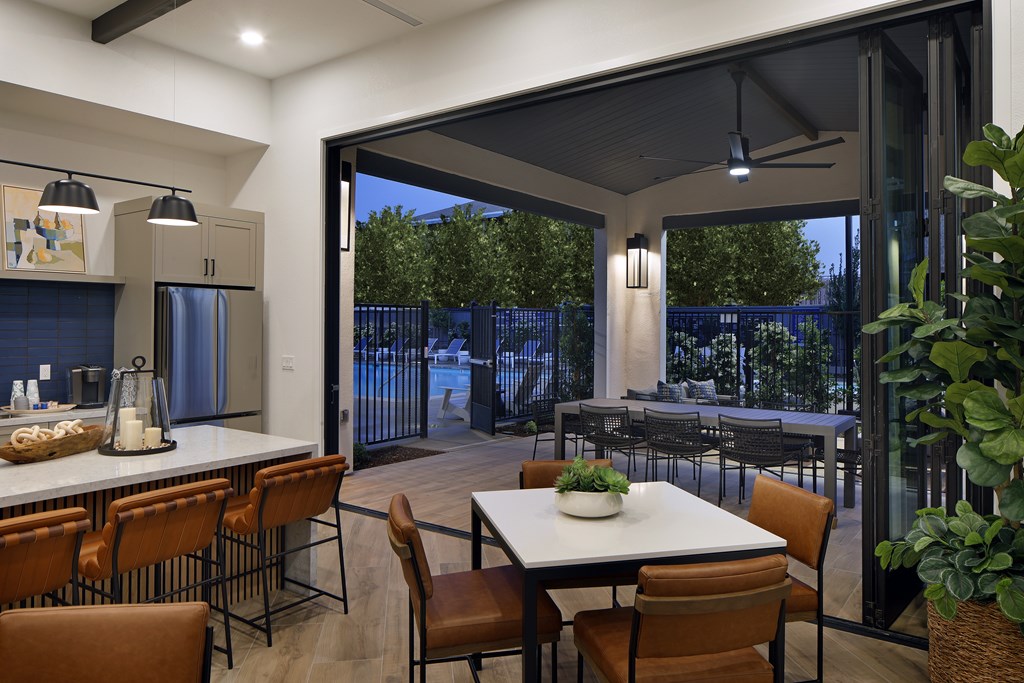 A modern kitchen with a dining table and chairs.