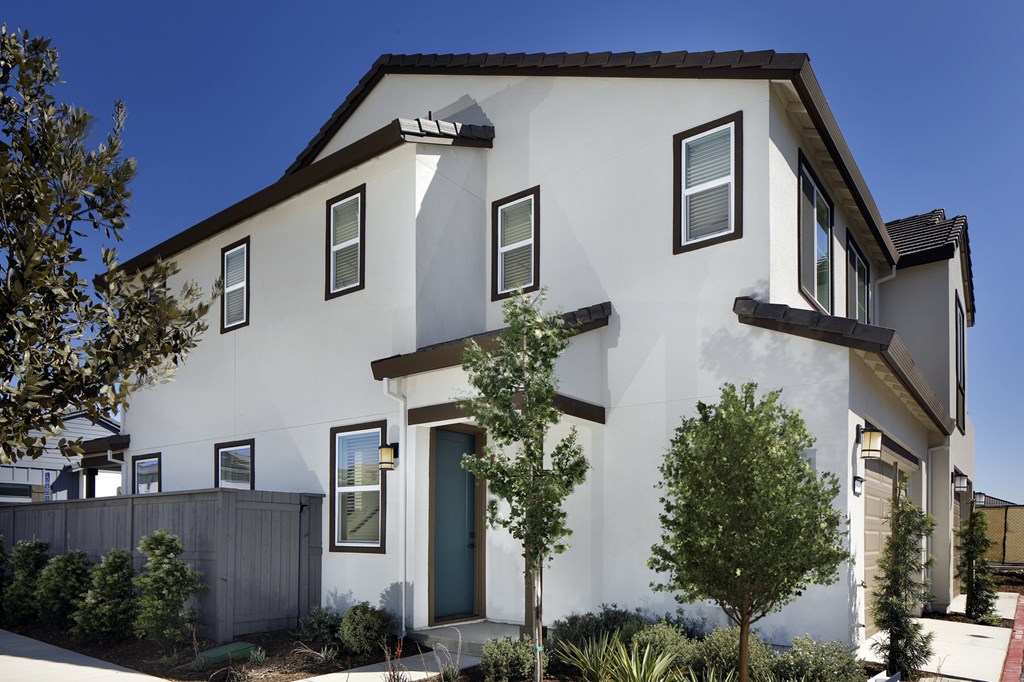 A white house with a green door and windows.
