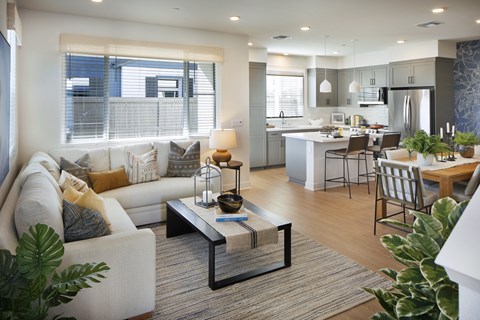 A modern living room with a white couch and a coffee table.
