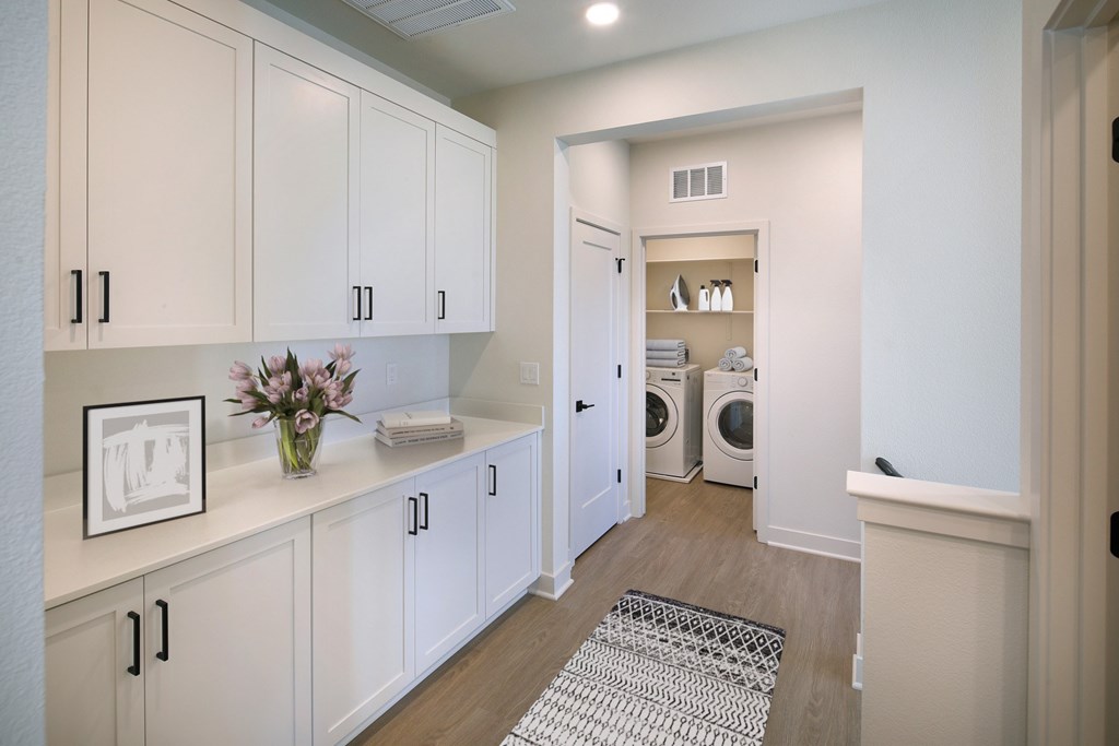 A laundry room with a washer and dryer in it.