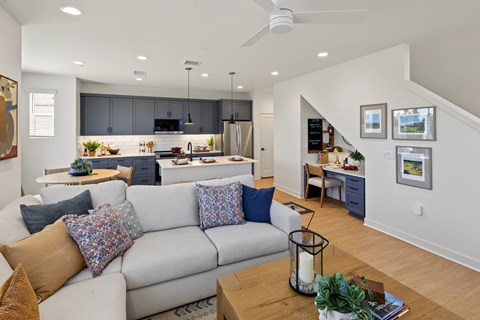 A modern living room with a grey sofa and a wooden coffee table.