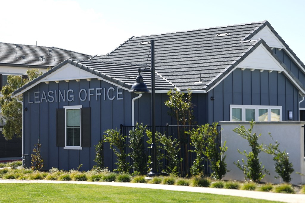 A blue building with a sign that says "Leasing Office".