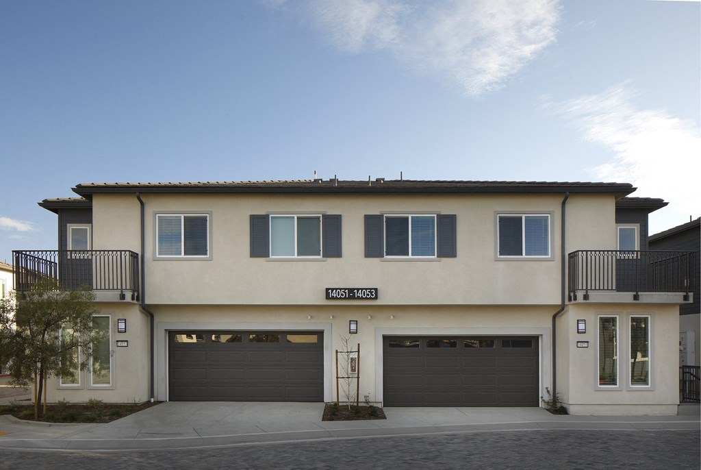A two-story building with a garage on the ground floor.