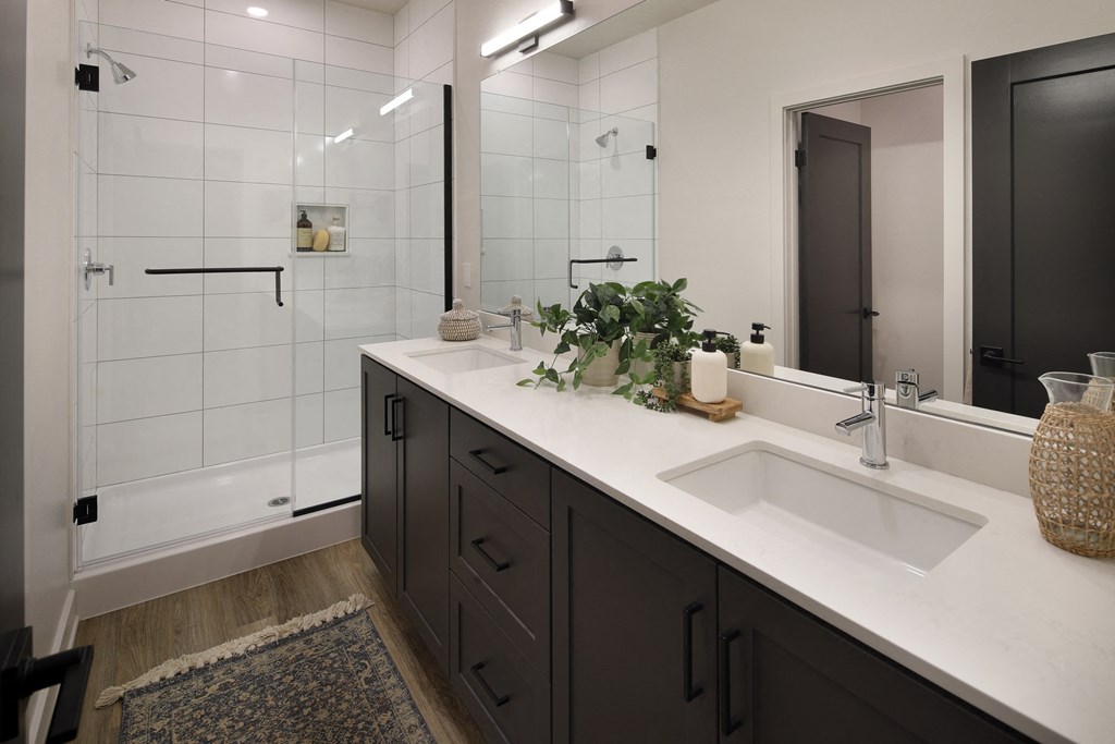 A bathroom with a white sink and a mirror.