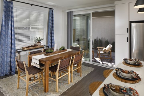 A dining room with a wooden table and chairs.
