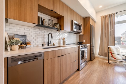 a kitchen with wooden cabinets and a sink and a window