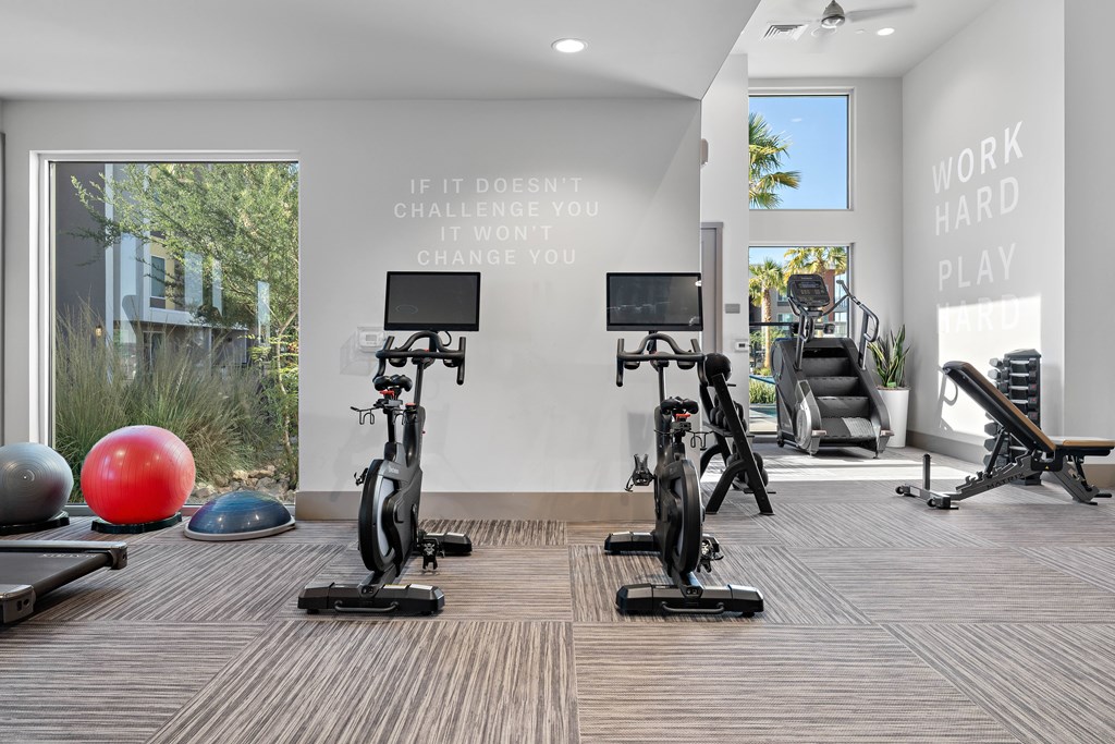 A gym with a motivational quote on the wall.