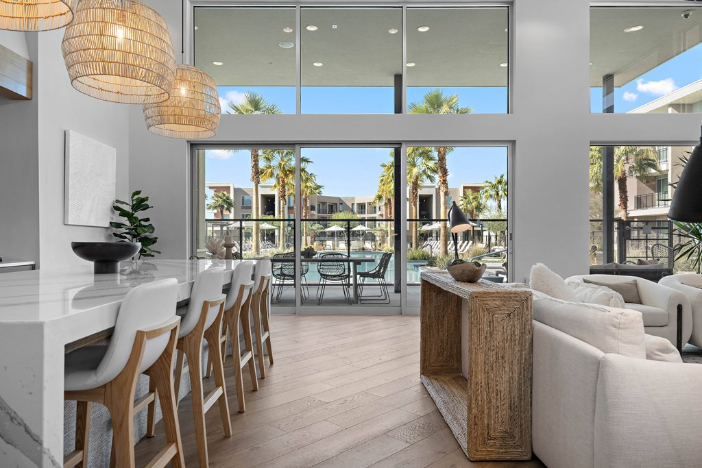 A modern living room with a dining area and a view of the outdoors.