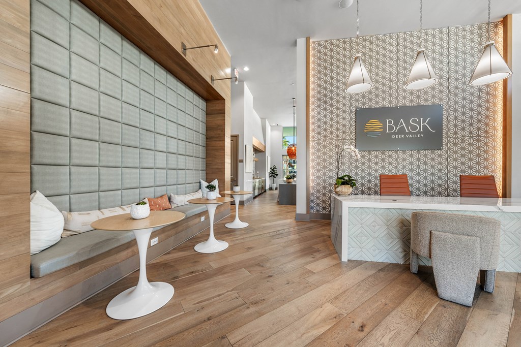 A modern cafe with wooden floors and white furniture.