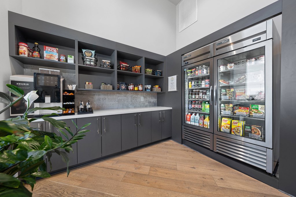 A modern kitchen with a refrigerator, shelves, and a plant.