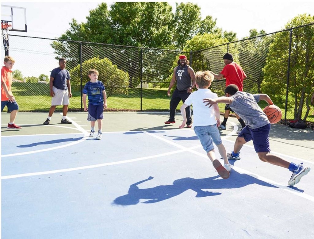 a group of young boys playing basketball on a court at The Madison at Adams Farm, Greensboro North Carolina 