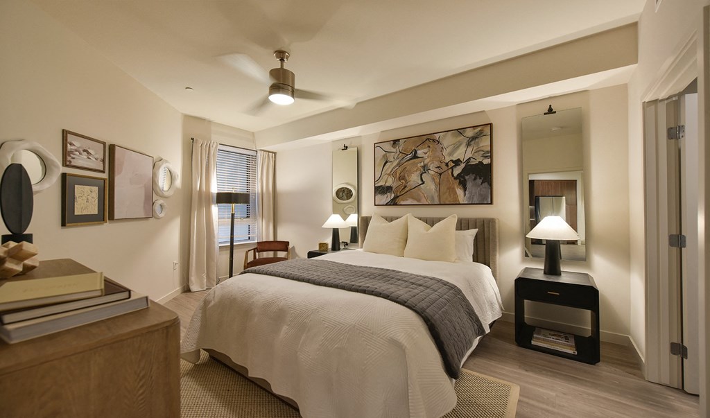 a bedroom with a bed and desk in a room