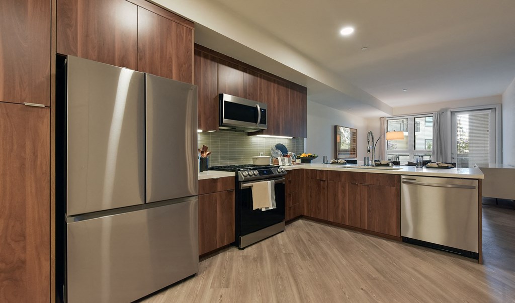 a kitchen with wooden cabinets and stainless steel appliances