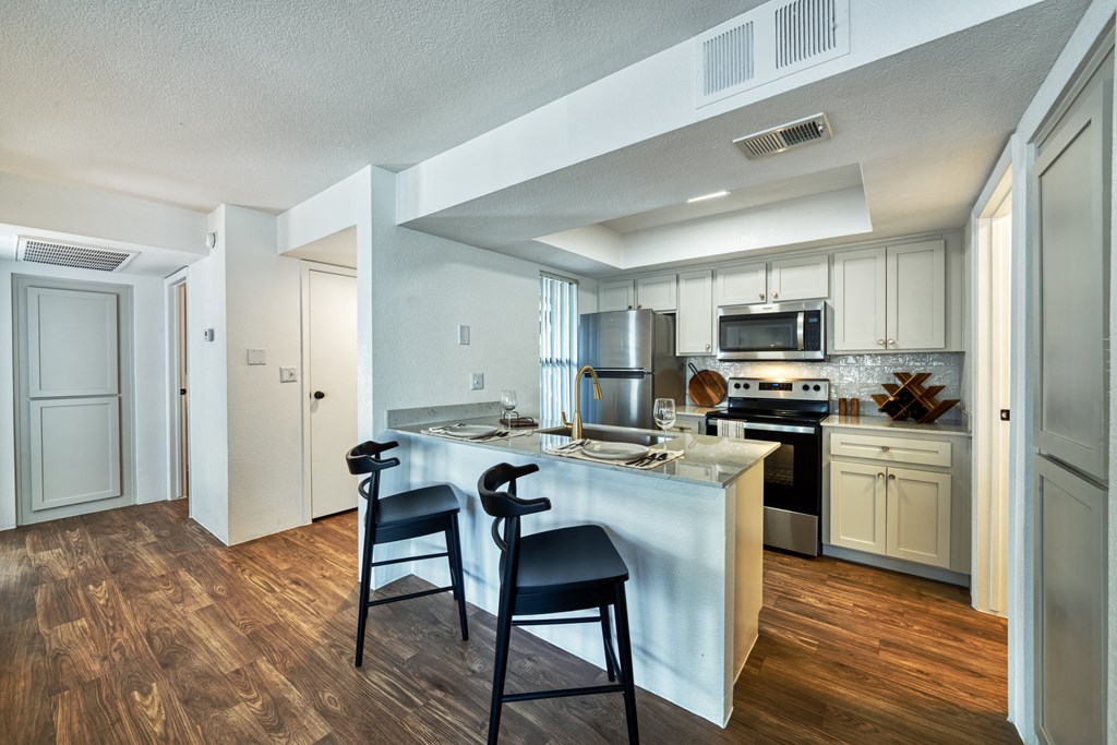 the preserve at ballantyne commons apartment kitchen with island and stools