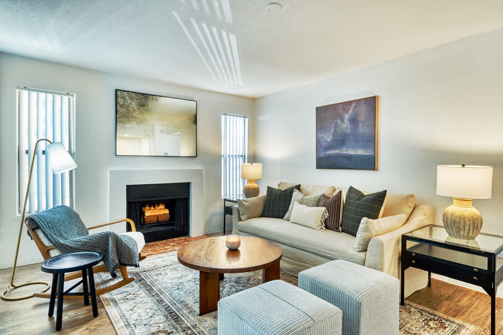 a living room with a couch and chairs and a fireplace