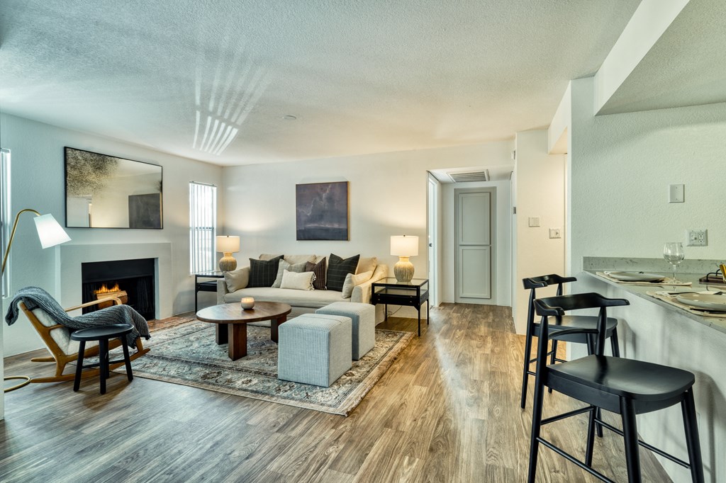 a living room with a couch and a table and a fireplace