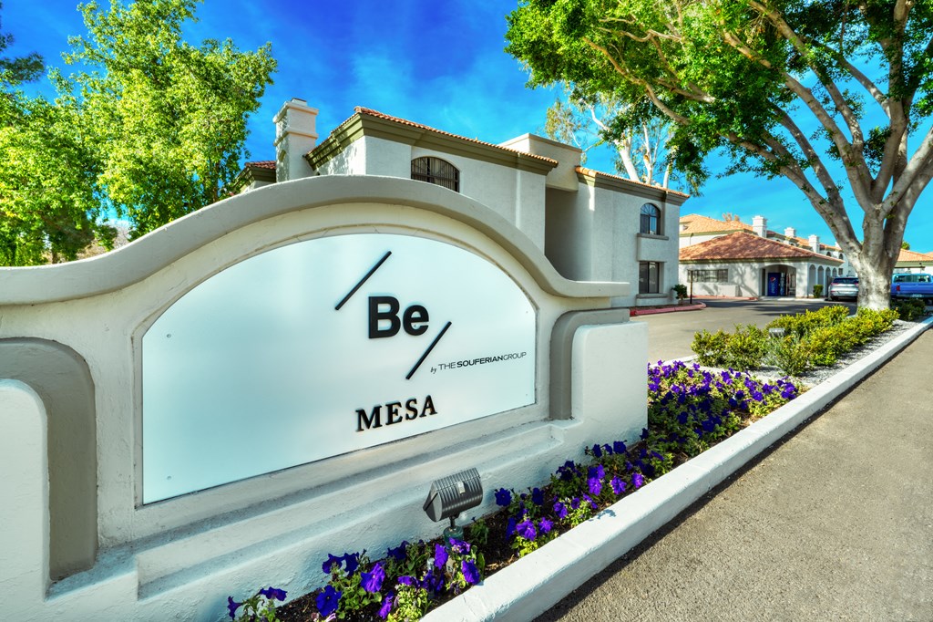 a sign that says be mesa in front of a building