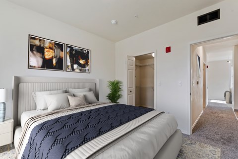 A bedroom with a large bed and a carpeted floor.
