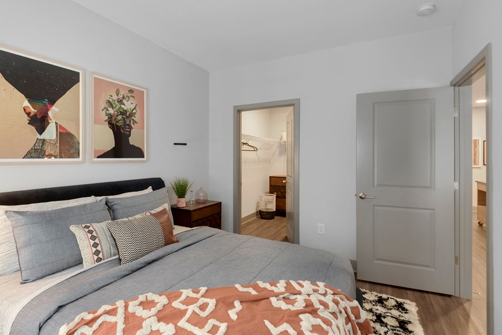 a bedroom with a large bed and a door to a bathroom