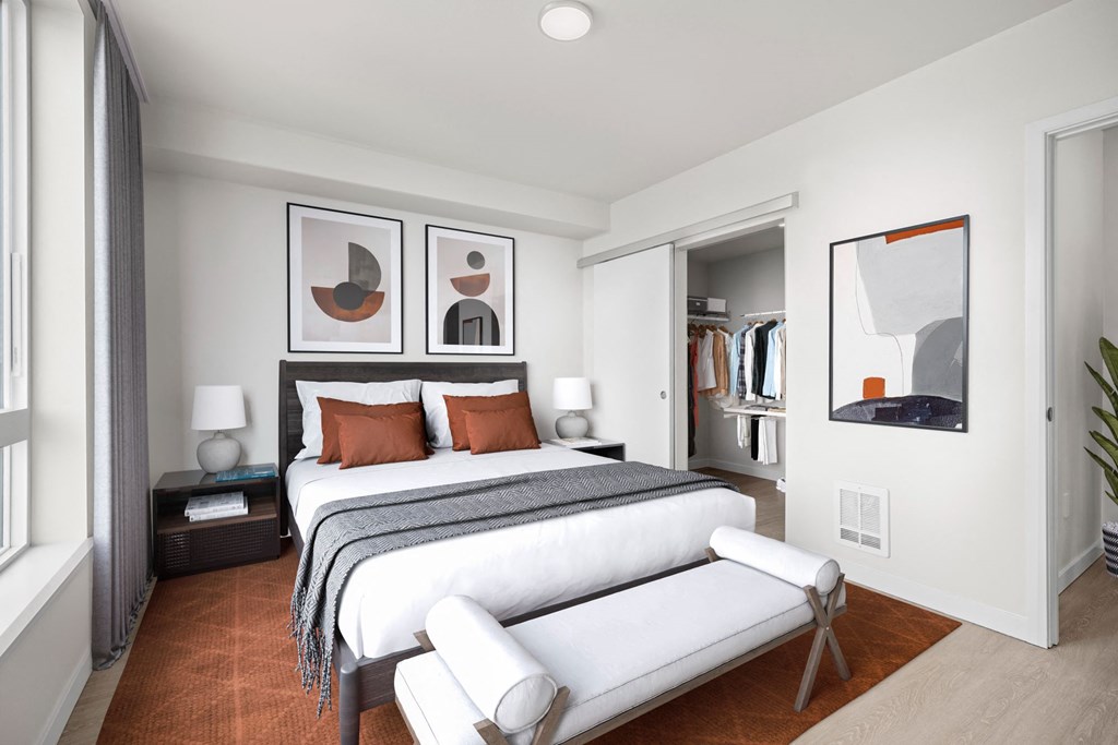 a bedroom with a bed and a chair in a room at Ion Town Center, Shoreline, WA