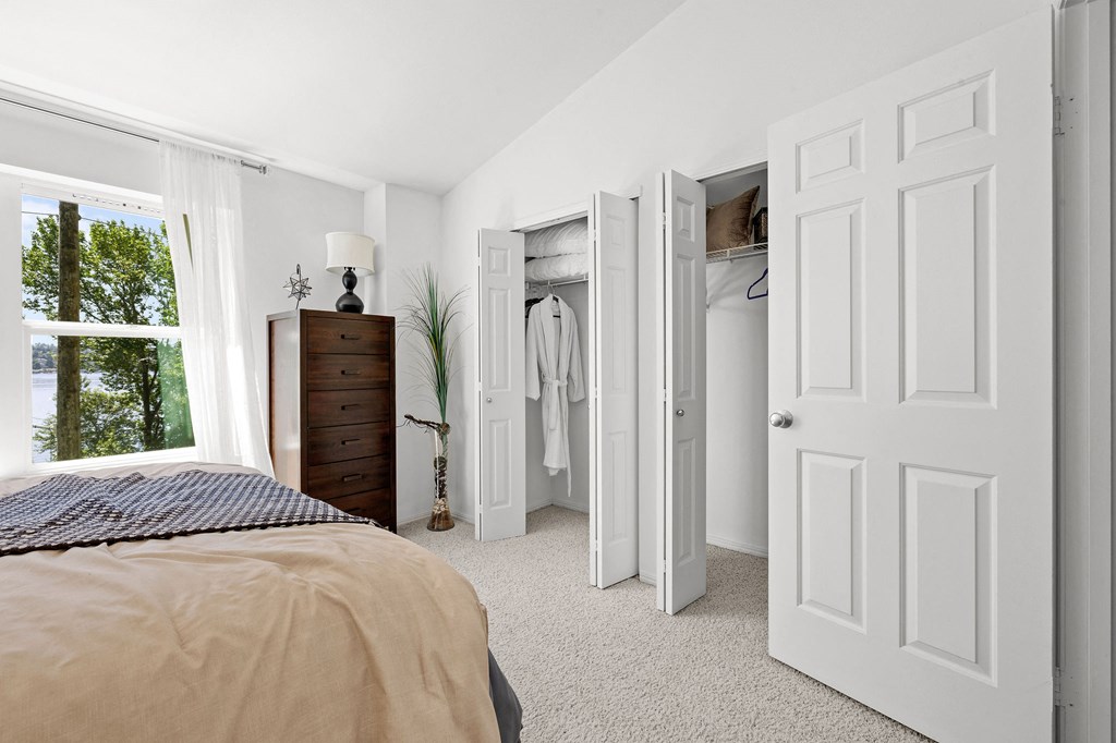 a bedroom with a bed and a dresser