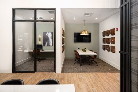 A conference room with a white table and chairs.