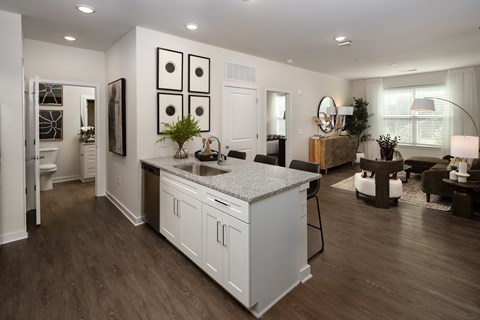 A modern kitchen with white cabinets and a wooden island.