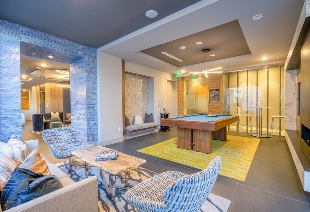 resident lounge with billiards, chairs, couch and table