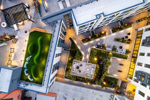 a view from above of a building with a green fountain in the middle of it