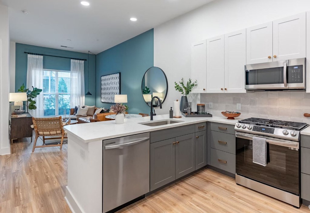 a kitchen with an island and stainless steel appliances