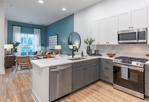 a kitchen with an island and a stove and a microwave