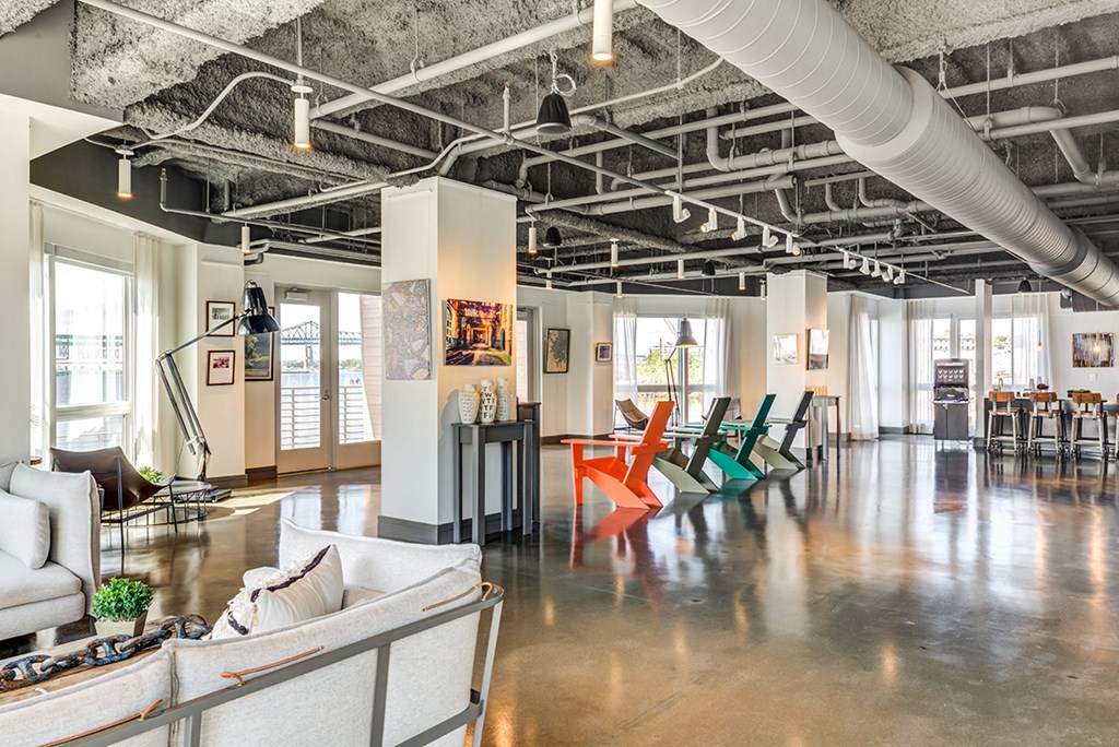 a living room with couches and chairs in a loft