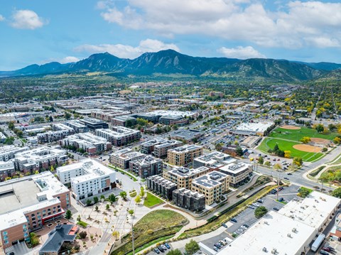 A cityscape with buildings and a mountain in the background.