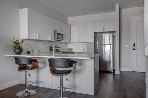 a kitchen with white cabinets and a white counter top