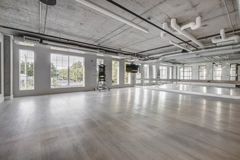 a large room with a dance floor and a large window
