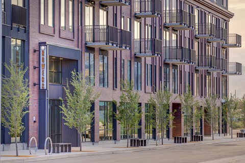 a rendering of a brick building with trees in front of it