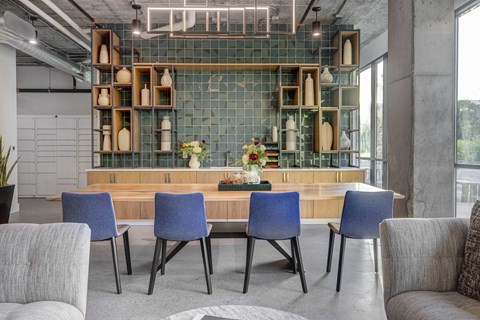 a dining room with blue chairs and a wooden table