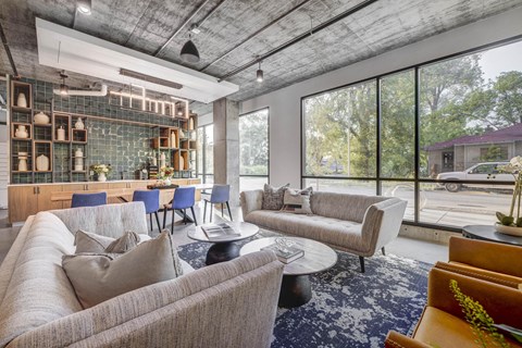 a living room filled with furniture and a large window