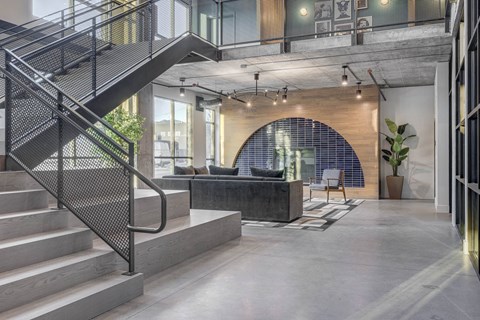 a large living room with a staircase leading up to the second floor