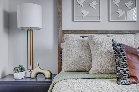 a bedroom with a bed and a lamp