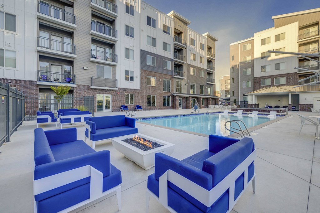 our apartments offer a pool and lounge area with blue furniture