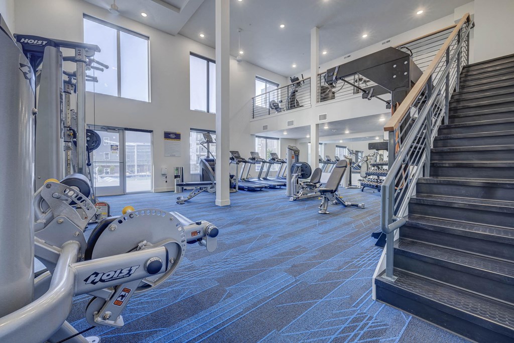 the gym at the flats at obsidian tower has cardio equipment and stairs