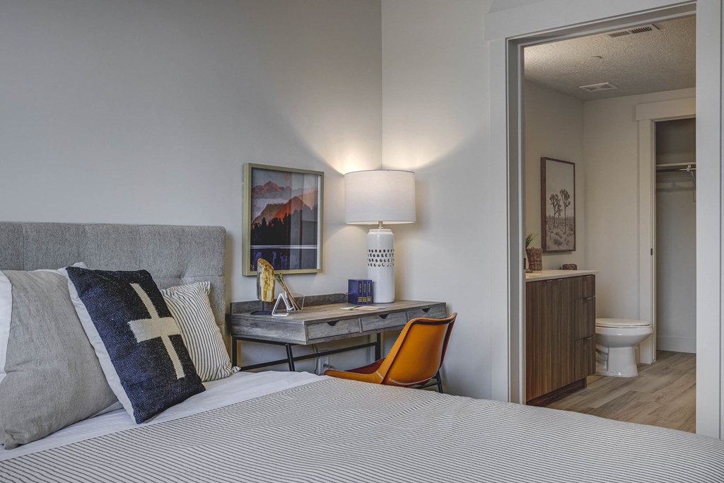 Close up of desk, next to open door leading to en-suite bathroom