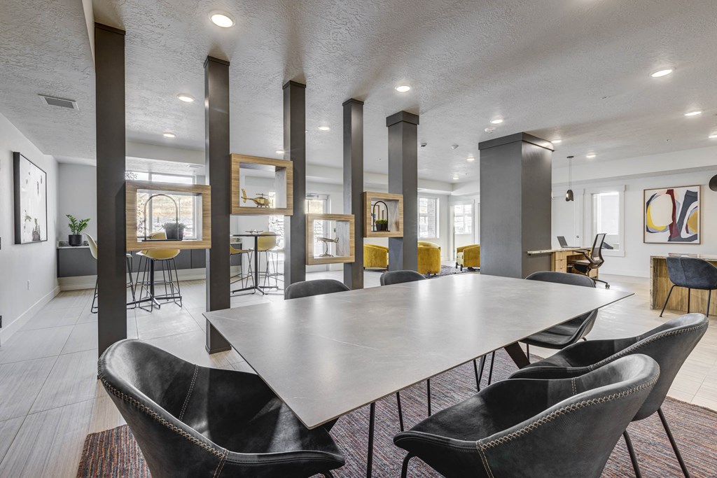 Meeting table with chairs in large room with gray beams