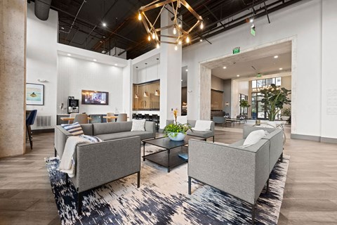 a lobby with couches and chairs and a rug