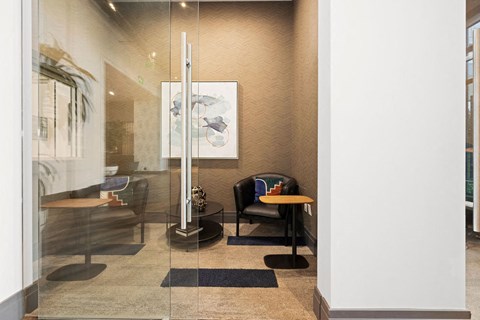 a room with a chair and a table in a lobby