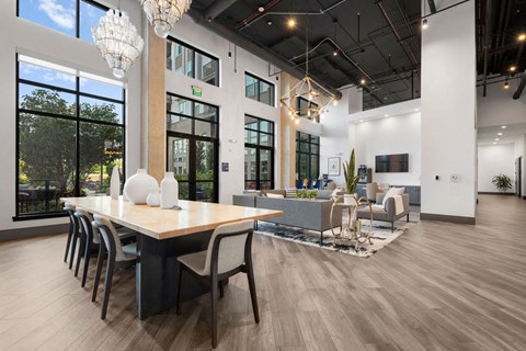 a dining room and living room with a table and chairs