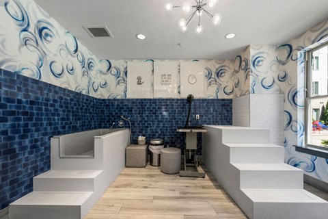 a blue and white bathroom with a tub and a sink