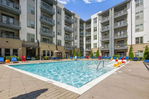 a swimming pool in front of an apartment building